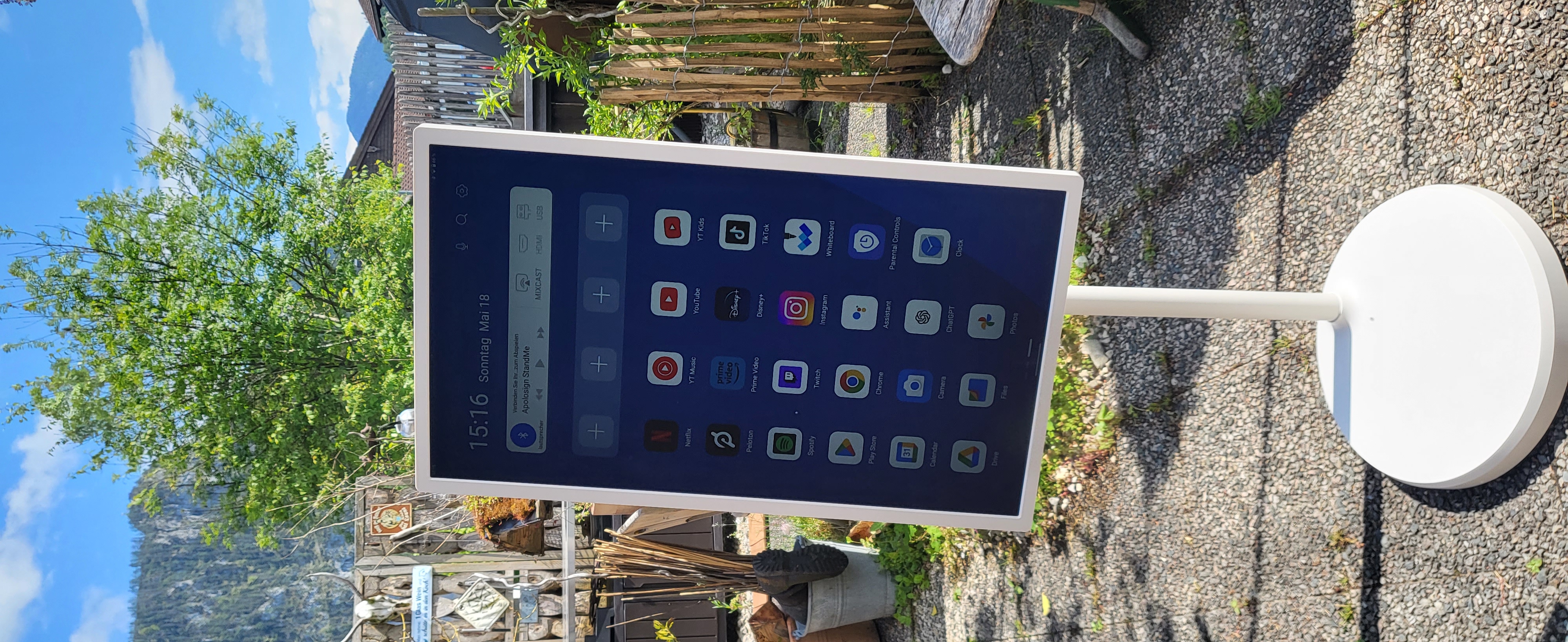Samsung Display im Freien auf einem weißen Ständer in einem Biergarten